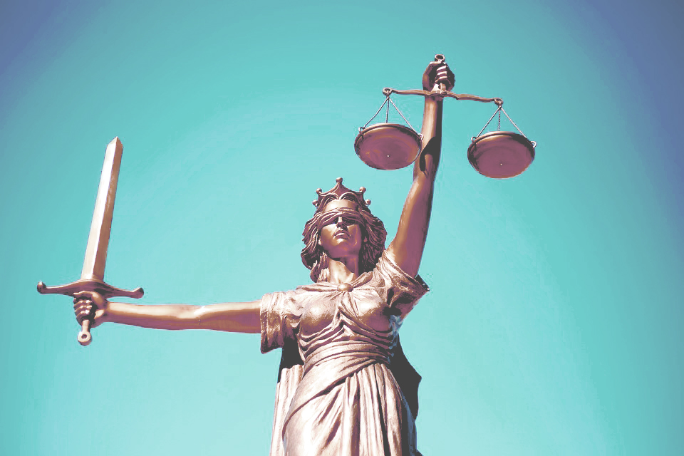 Lady Justice holds scales to represent the impartiality of the court’s decisions and a sword as a symbol of the power of justice.
